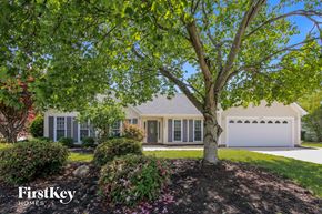 Charlotte house for rent - a home with a large tree in front of it