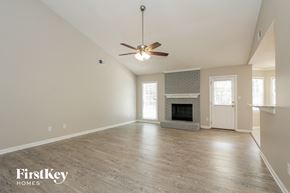 Charlotte house for rent - the spacious living room with fireplace and ceiling fan