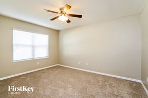 Cape Coral house for rent - a bedroom with a ceiling fan and a window