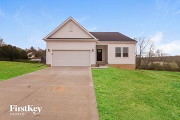 Lancaster house for rent - a small white house with a driveway in front of a field