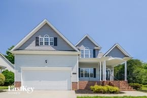 High Point house for rent - A two-story house with a garage and a covered porch.