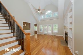 High Point house for rent - A spacious home interior with a staircase and a fireplace.