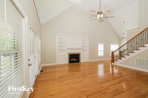 High Point house for rent - A spacious living room with a fireplace and hardwood floors.