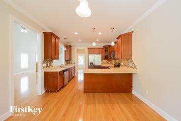 High Point house for rent - A well-lit kitchen with wooden cabinets and a central island.