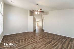 San Tan Valley house for rent - a living room with white walls and a ceiling fan
