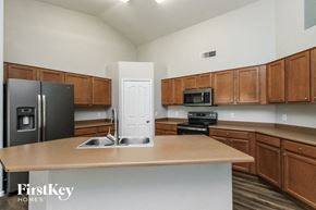San Tan Valley house for rent - a kitchen with wooden cabinets and stainless steel appliances