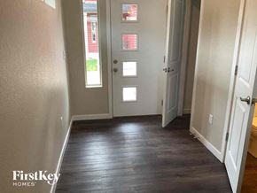Castle Rock house for rent - a hallway with a hard wood floor and white doors