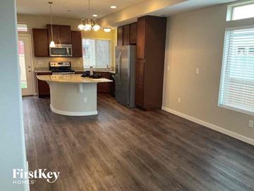 Castle Rock house for rent - a kitchen with wooden floors and a stainless steel refrigerator
