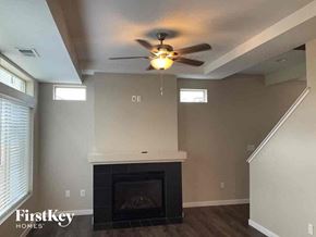 Castle Rock house for rent - a living room with a ceiling fan and a fireplace