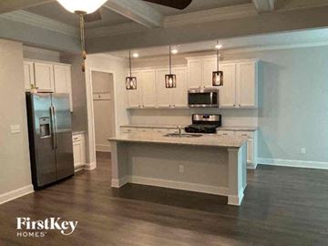 Jefferson house for rent - a kitchen with white cabinets and a stainless steel refrigerator