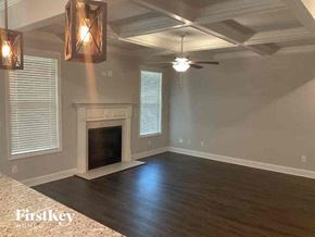 Jefferson house for rent - a empty living room with a fireplace and a ceiling fan
