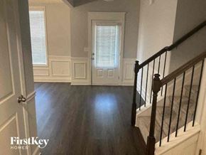 Jefferson house for rent - a living room with a staircase and wood floors