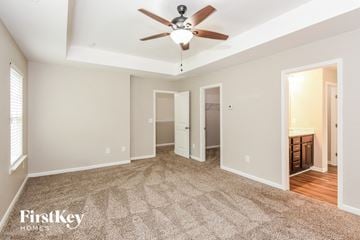 Canton house for rent - a living room with carpet and a ceiling fan