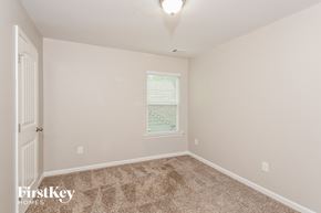 Canton house for rent - a bedroom with carpet and a window and a door
