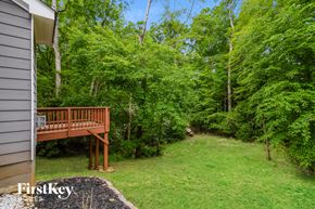 Canton house for rent - a backyard with a wooden deck and trees