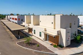 Glendale apartment for rent - A modern building with a parking lot in front.