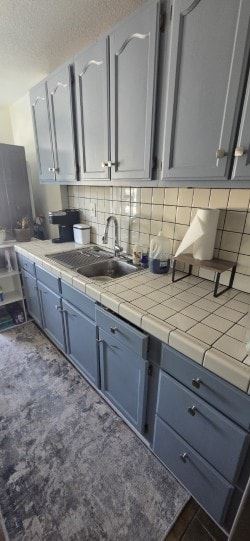 Los Angeles apartment for rent - A kitchen with blue cabinets and a white tiled backsplash.