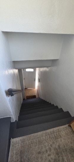 Los Angeles apartment for rent - A staircase with a carpeted runner and a white wall.