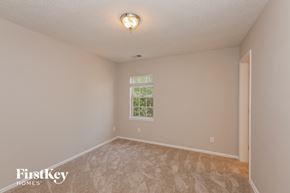 Charlotte house for rent - the spacious living room with carpeting and a window