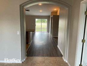 Cape Coral house for rent - a hallway of a house with a hard wood floor