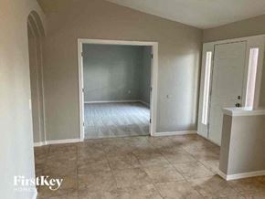 Cape Coral house for rent - an empty room with a tile floor and an open door