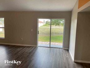 Cape Coral house for rent - an empty living room with a sliding glass door