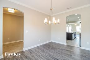 Winston-Salem house for rent - A room with a chandelier and a mirror on the wall.