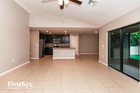 North Port house for rent - A spacious kitchen with a black refrigerator and a white island.