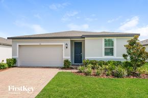 New Smyrna Beach house for rent - A house with a garage door and a blue door is shown.
