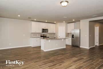 New Smyrna Beach house for rent - A kitchen with wooden floors and white walls.