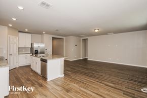 New Smyrna Beach house for rent - A spacious kitchen and living room with wooden flooring and white walls.