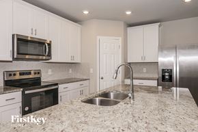 New Smyrna Beach house for rent - A kitchen with granite countertops and stainless steel appliances.