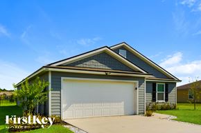 Jacksonville house for rent - a garage with a white door in front of a house