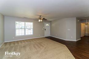 Douglasville house for rent - the living room of an empty house with a ceiling fan