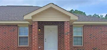 Hattiesburg house for rent - A red brick house with a white door and windows.