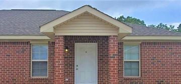 Hattiesburg house for rent - A red brick house with a white door and windows.