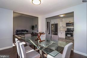 Cherry Hill house for rent - A dining room with a glass table and grey chairs.
