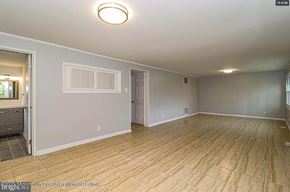 Cherry Hill house for rent - A spacious room with wooden flooring and a ceiling light.