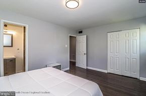 Cherry Hill house for rent - A bedroom with a large bed and a white door.