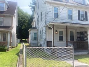 Mount Holly apartment for rent - A white house with a black fence in front.