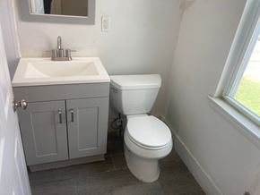 Mount Holly apartment for rent - A white toilet sits next to a sink in a bathroom.