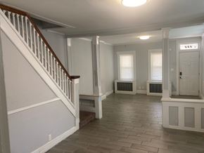 Mount Holly apartment for rent - A spacious room with a staircase and radiators.