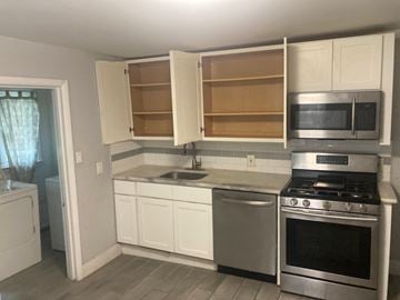 Mount Holly apartment for rent - A kitchen with white cabinets and a stainless steel oven.