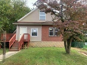 Stratford apartment for rent - A house with a red staircase and a tree in front.