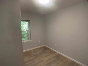 Stratford apartment for rent - A room with a window and wooden flooring.