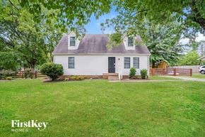 Murfreesboro house for rent - a small white house with a yard and a wooden fence