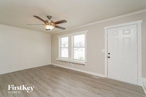 Murfreesboro house for rent - a bedroom with a ceiling fan and a white door