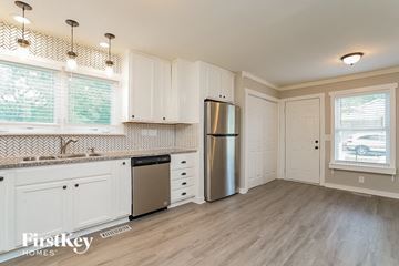 Murfreesboro house for rent - a kitchen with white cabinets and a stainless steel refrigerator
