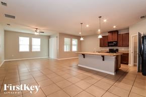 Orange City house for rent - an open kitchen and living room with tile flooring