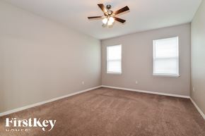 Orange City house for rent - the upstairs bedroom with carpet and ceiling fan and two windows